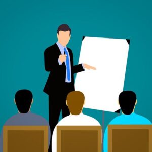 boss pointing to board in meeting